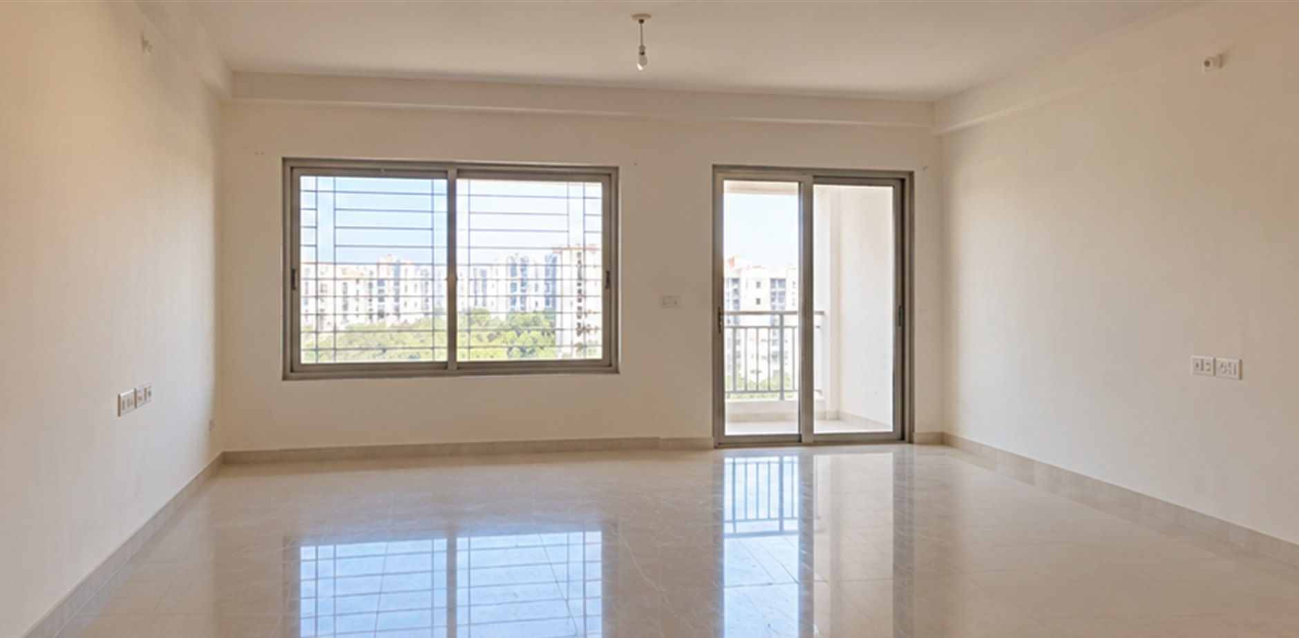 Empty room with bare white walls and no interior work